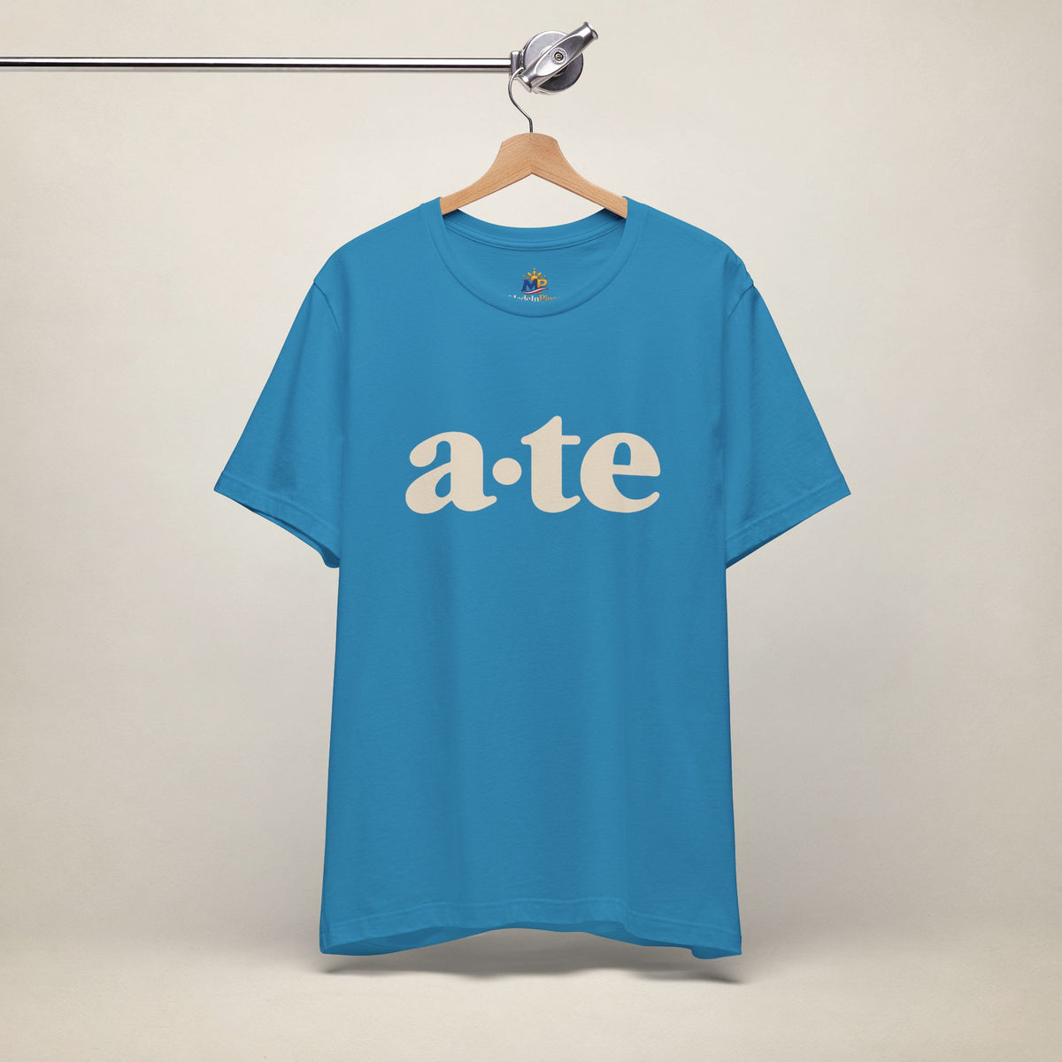 Aqua MadeInPinas ATE Filipino T-shirt on a hanger, front view with minimalist a·te lettering.