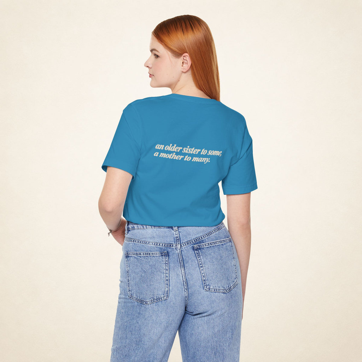 Model wearing the Aqua ATE Filipino T-shirt from behind, with the message “an older sister to some, a mother to many.”