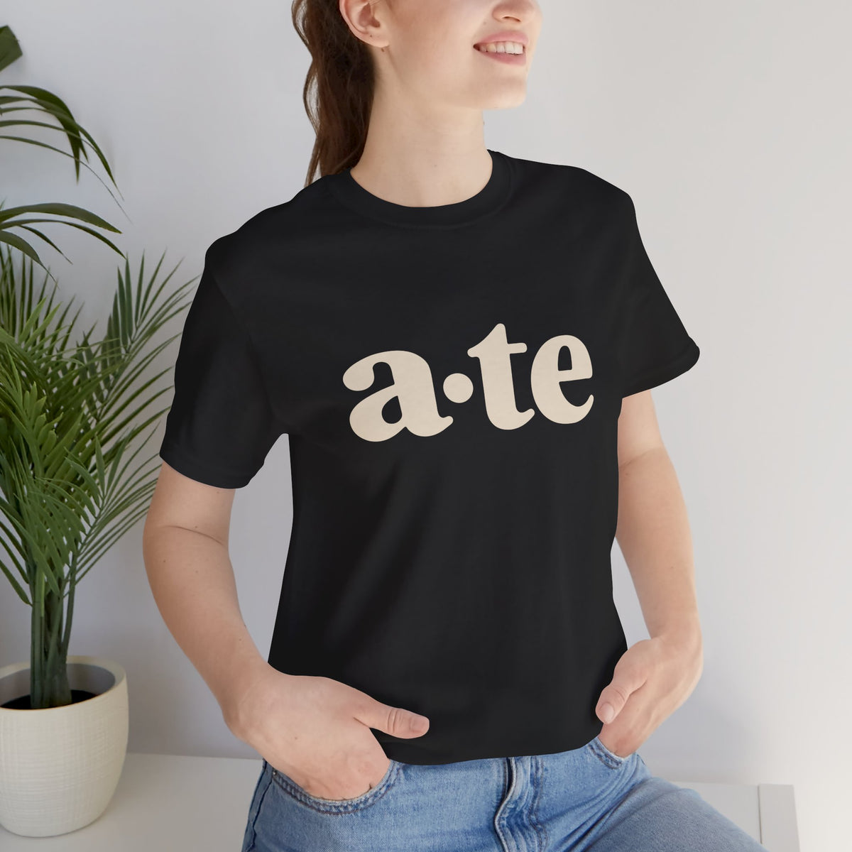 Lifestyle front view of a model wearing the Black ATE Filipino T-shirt with minimalist a·te lettering.