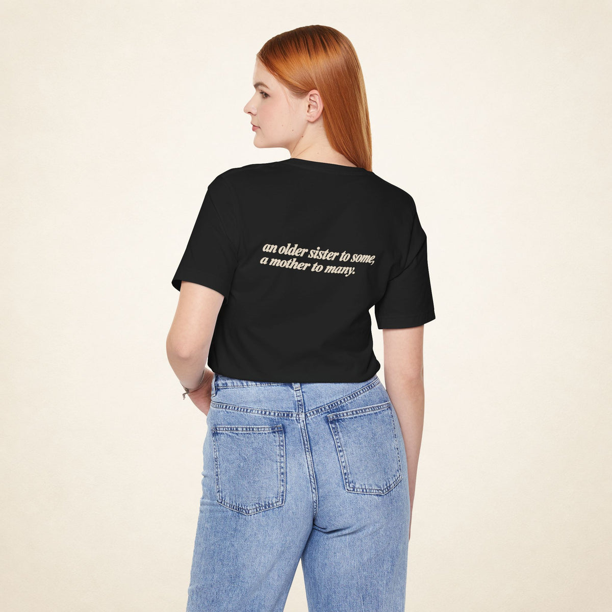 Model wearing the Black ATE Filipino T-shirt from behind, with the message “an older sister to some, a mother to many.”