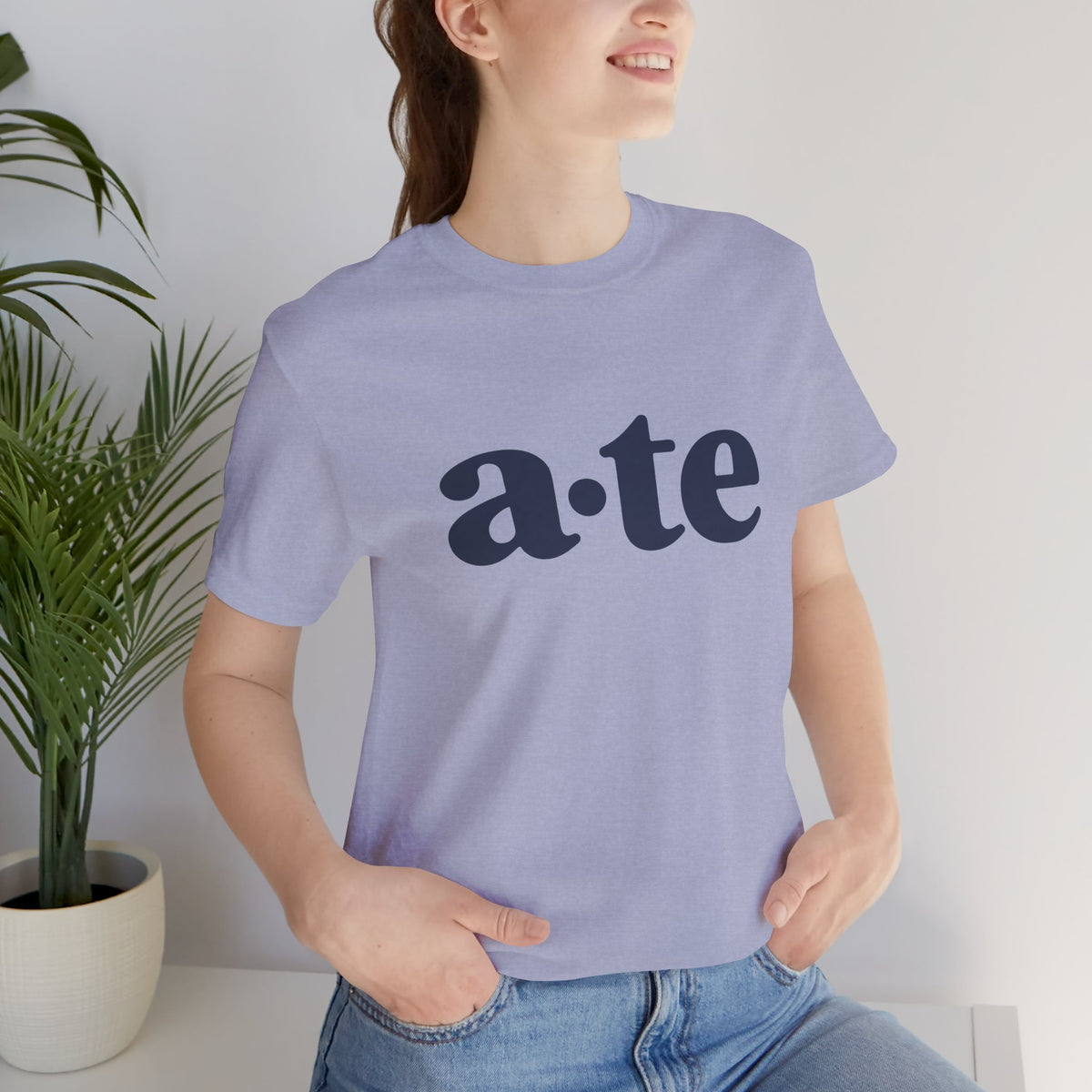 Lifestyle front view of a model wearing the Heather Blue ATE Filipino T-shirt with minimalist a·te lettering.