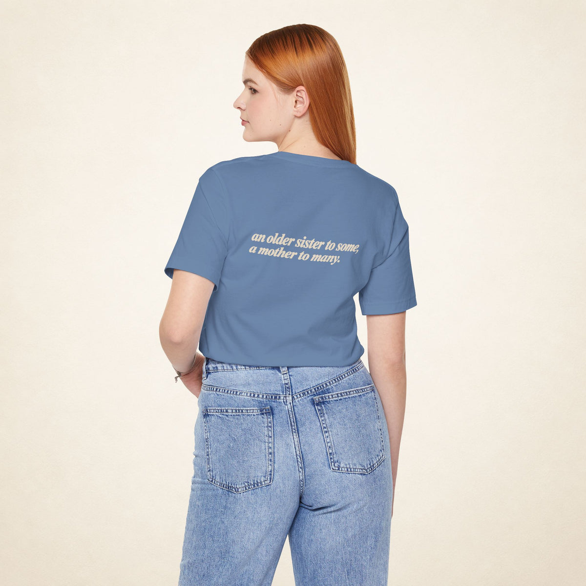 Model wearing the Lavender Blue ATE Filipino T-shirt from behind, with the message “an older sister to some, a mother to many.”