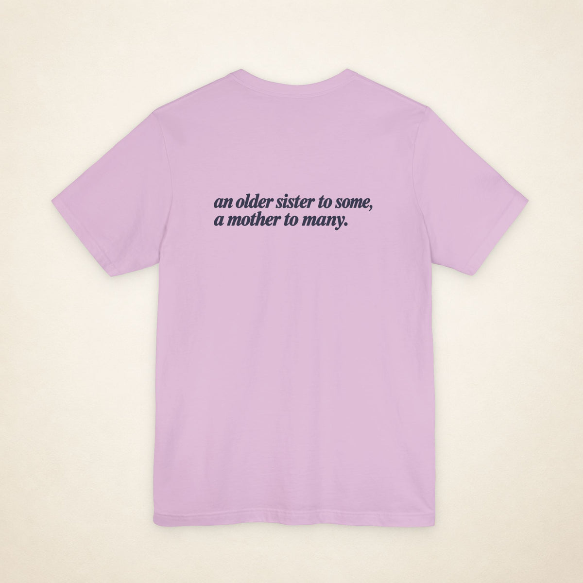 Lilac ATE Filipino T-shirt, flat-lay back view with the message “an older sister to some, a mother to many.”