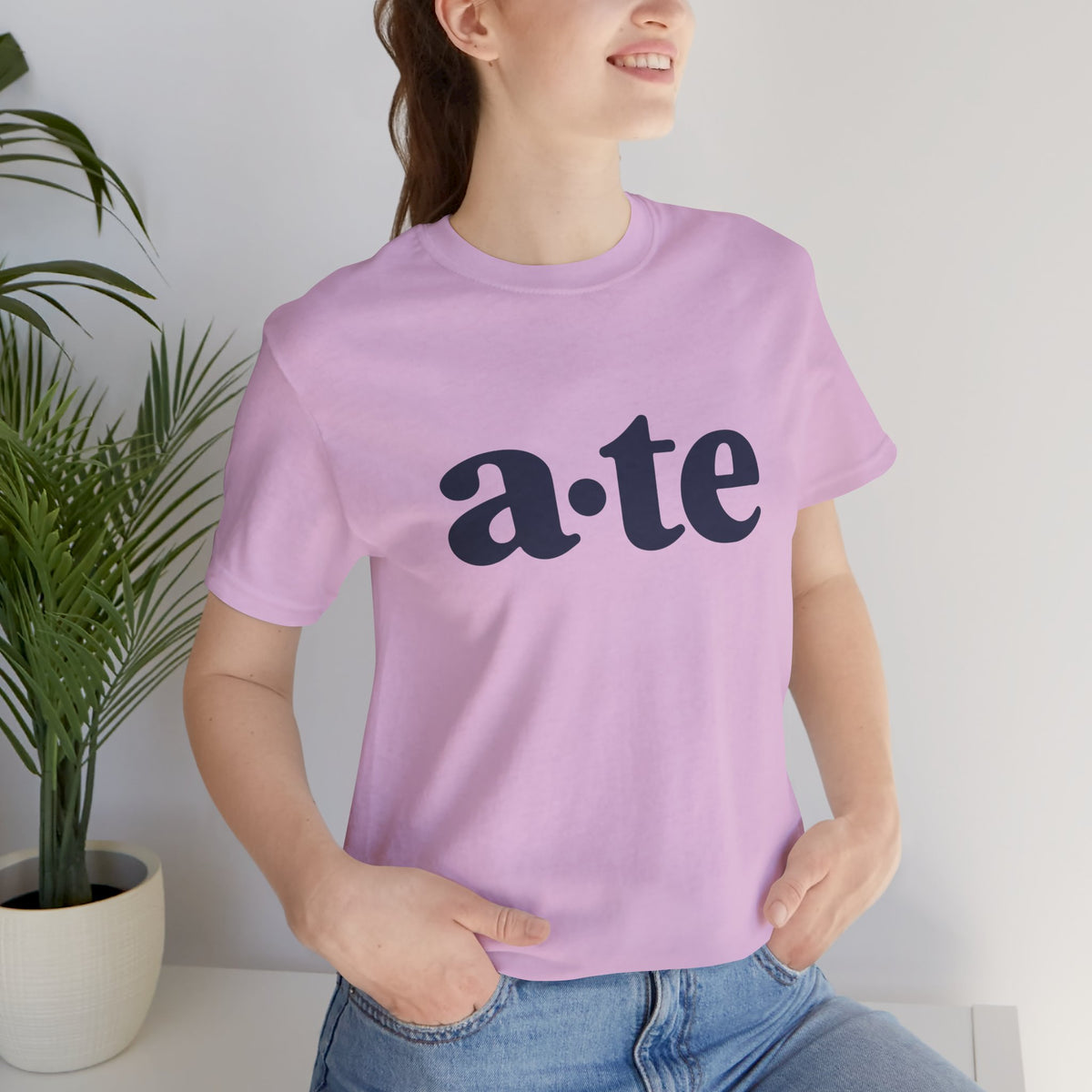 Lifestyle front view of a model wearing the Lilac ATE Filipino T-shirt with minimalist a·te lettering.
