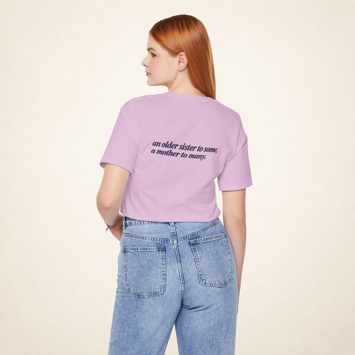 Model wearing the Lilac ATE Filipino T-shirt from behind, with the message “an older sister to some, a mother to many.”