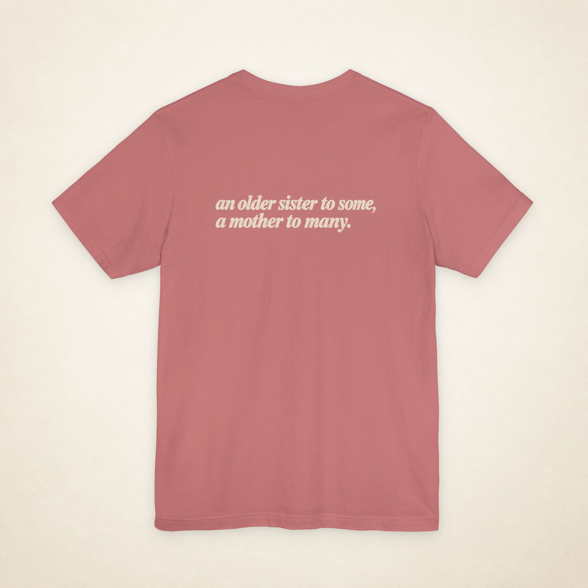 Mauve ATE Filipino T-shirt, flat-lay back view with the message “an older sister to some, a mother to many.”