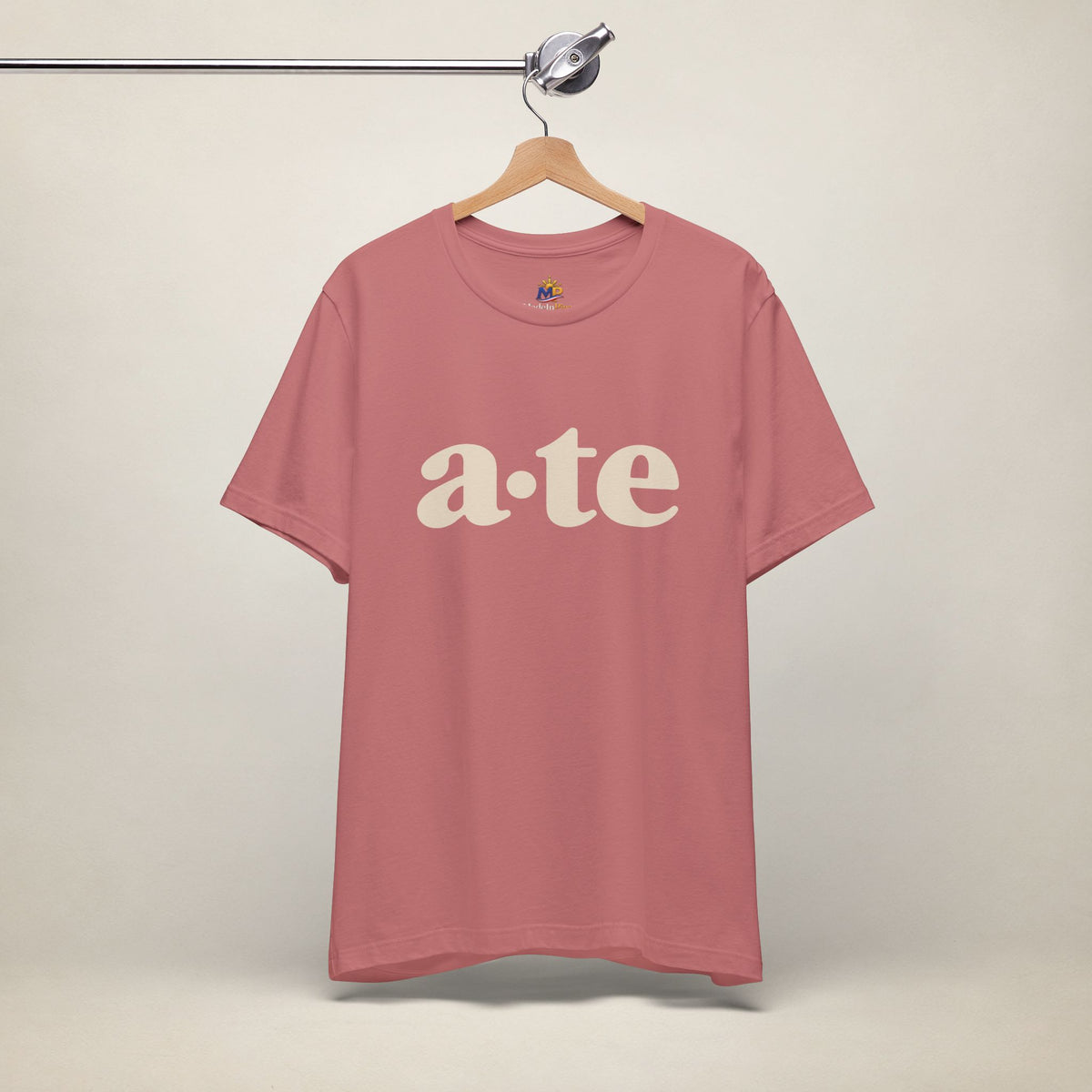 Mauve MadeInPinas ATE Filipino T-shirt on a hanger, front view with minimalist a·te lettering.