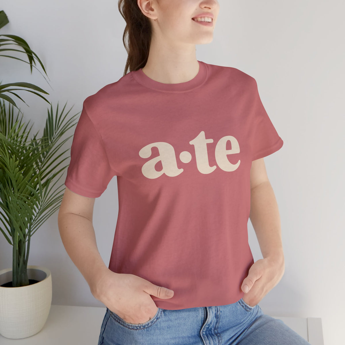 Lifestyle front view of a model wearing the Mauve ATE Filipino T-shirt with minimalist a·te lettering.