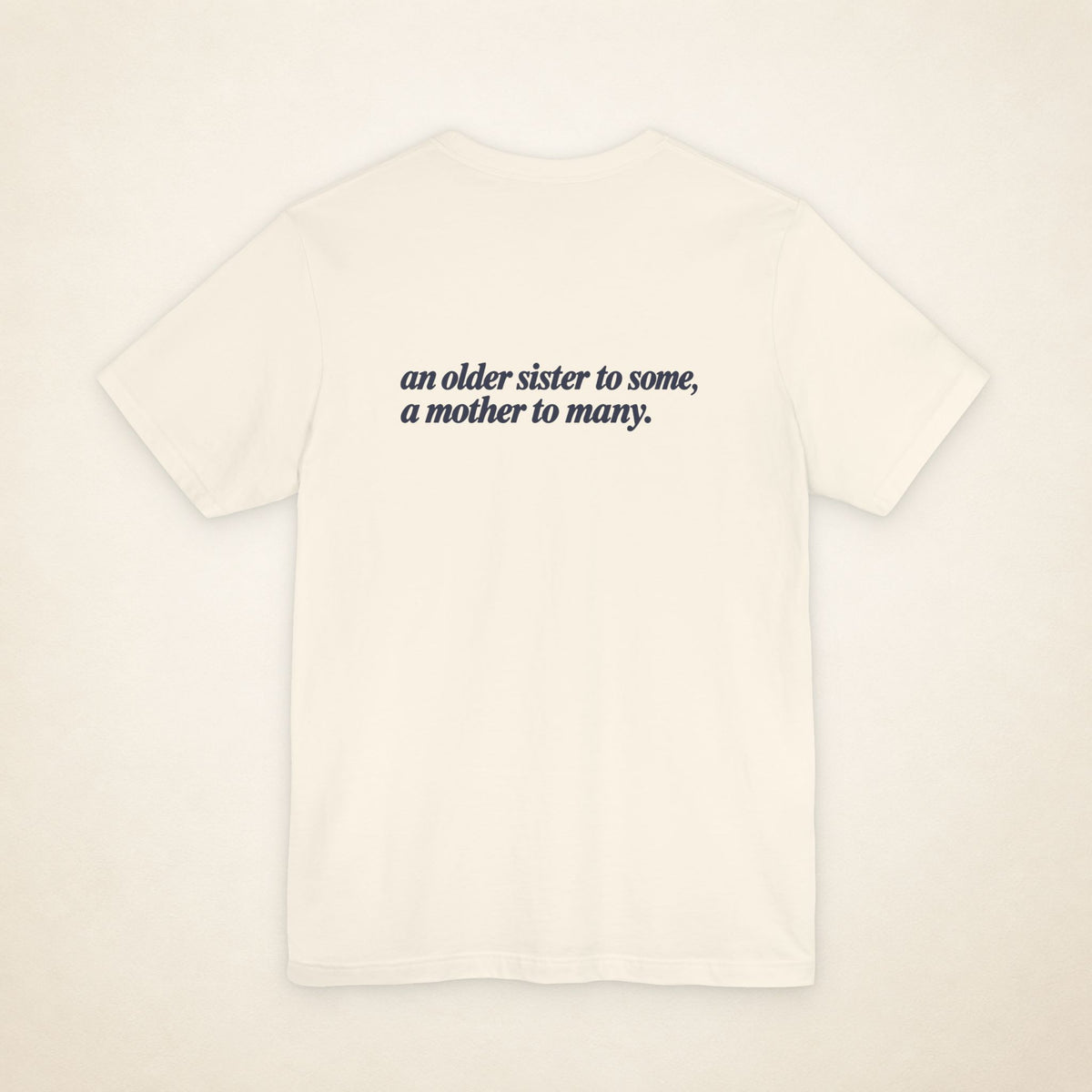 Natural ATE Filipino T-shirt, flat-lay back view with the message “an older sister to some, a mother to many.”
