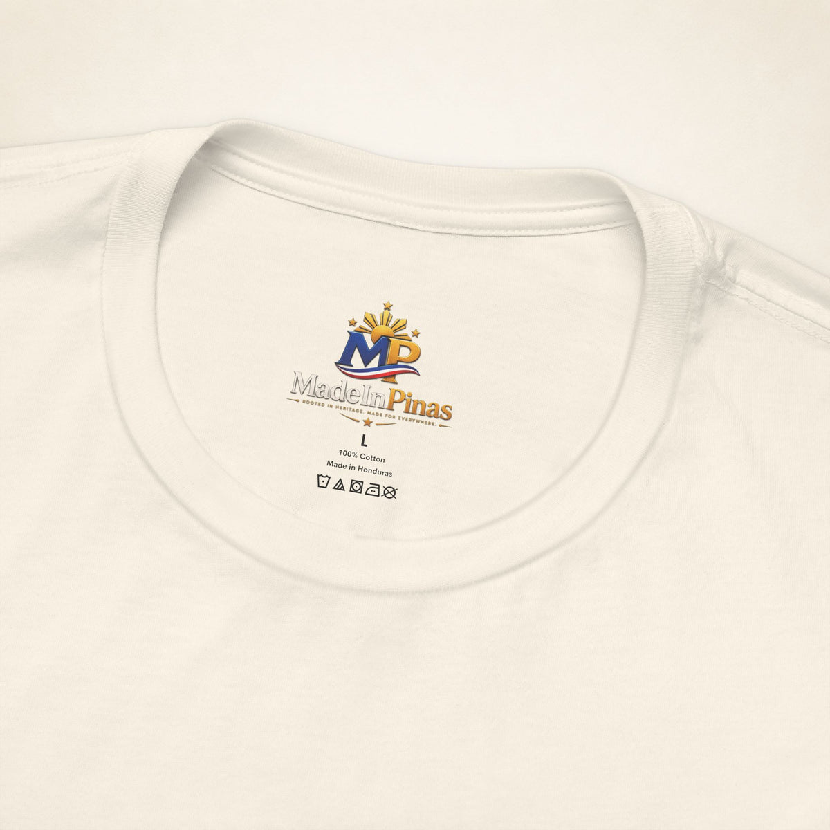 Close-up of the Natural ATE T-shirt collar showing the printed MadeInPinas inner-neck logo.