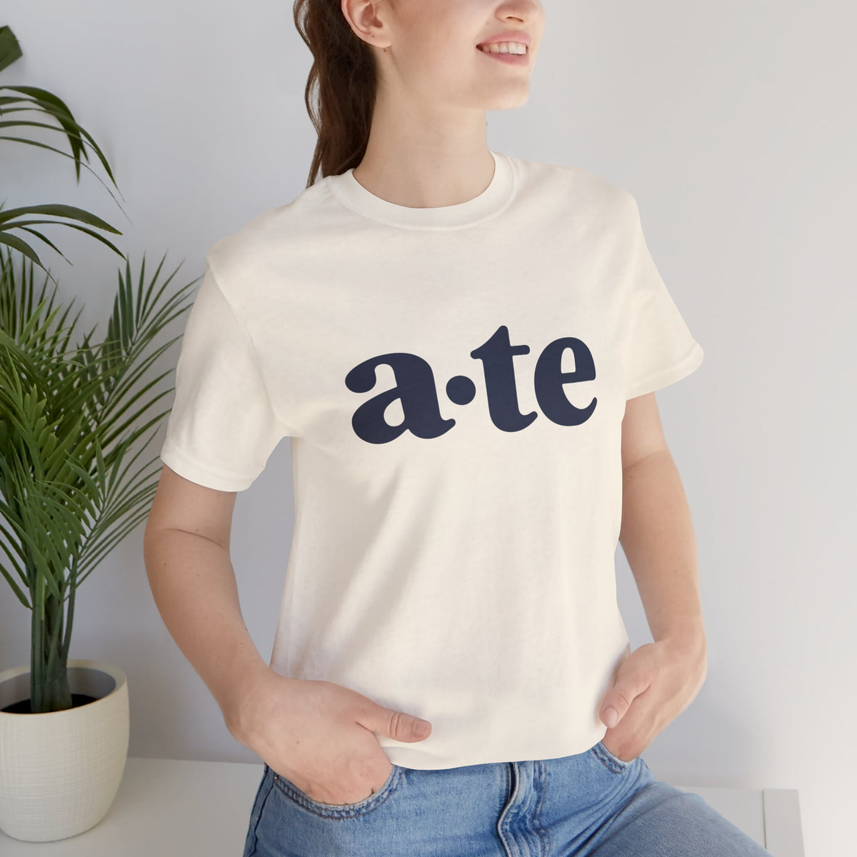 Lifestyle front view of a model wearing the Natural ATE Filipino T-shirt with minimalist a·te lettering.