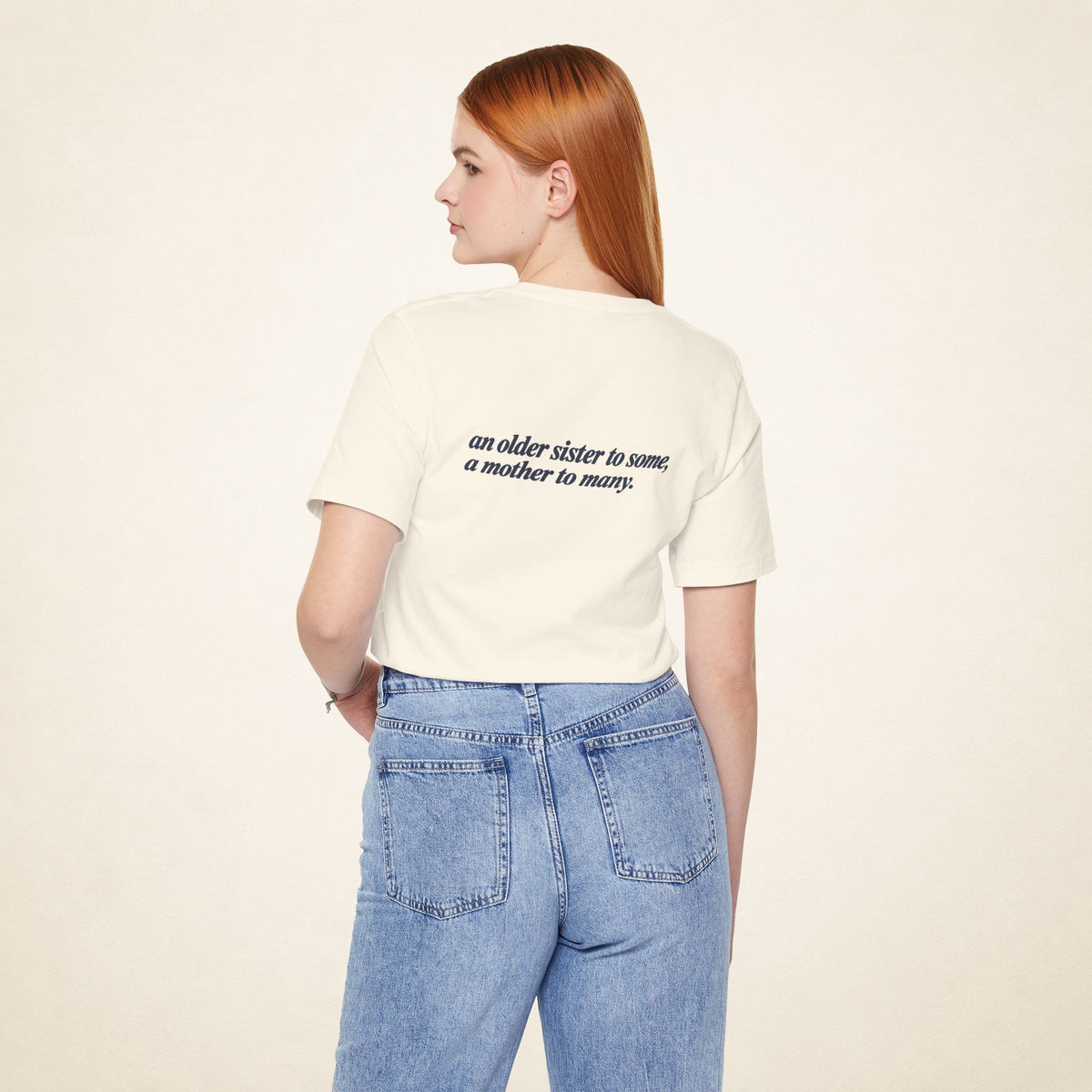 Model wearing the Natural ATE Filipino T-shirt from behind, with the message “an older sister to some, a mother to many.”