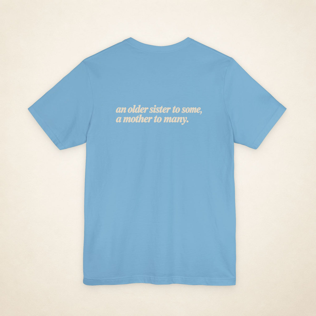 Ocean Blue ATE Filipino T-shirt, flat-lay back view with the message “an older sister to some, a mother to many.”