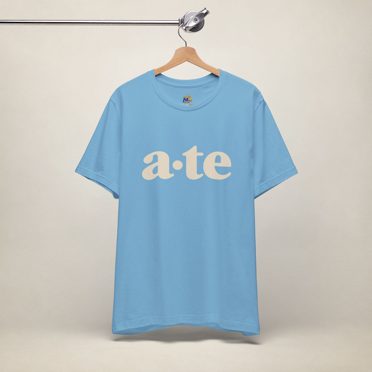 Ocean Blue MadeInPinas ATE Filipino T-shirt on a hanger, front view with minimalist a·te lettering.