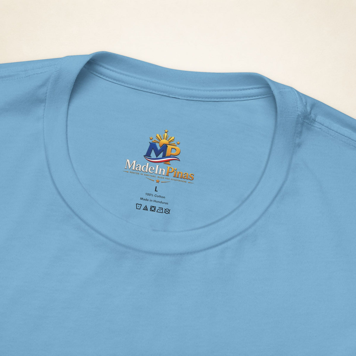 Close-up of the Ocean Blue ATE T-shirt collar showing the printed MadeInPinas inner-neck logo.