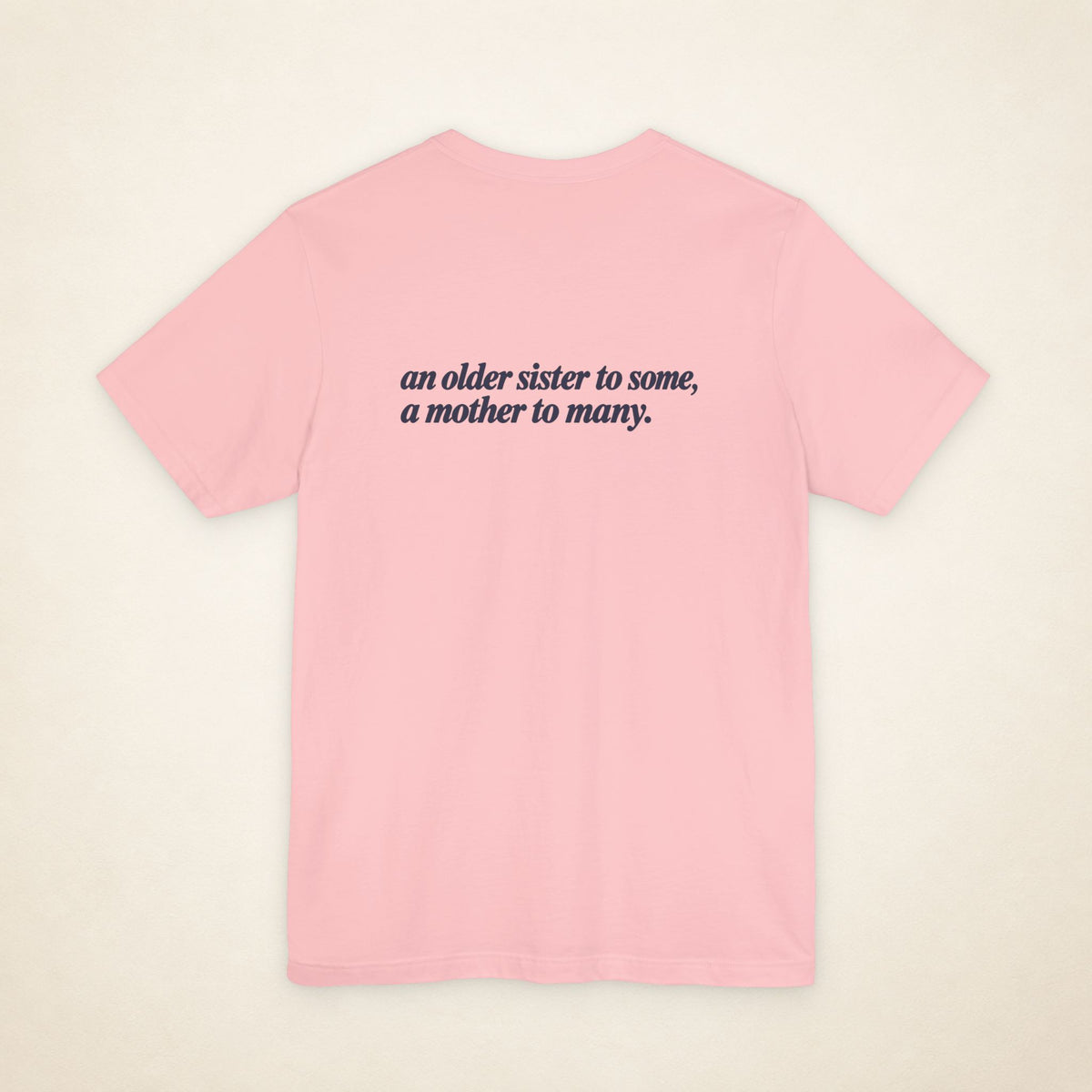 Pink ATE Filipino T-shirt, flat-lay back view with the message “an older sister to some, a mother to many.”