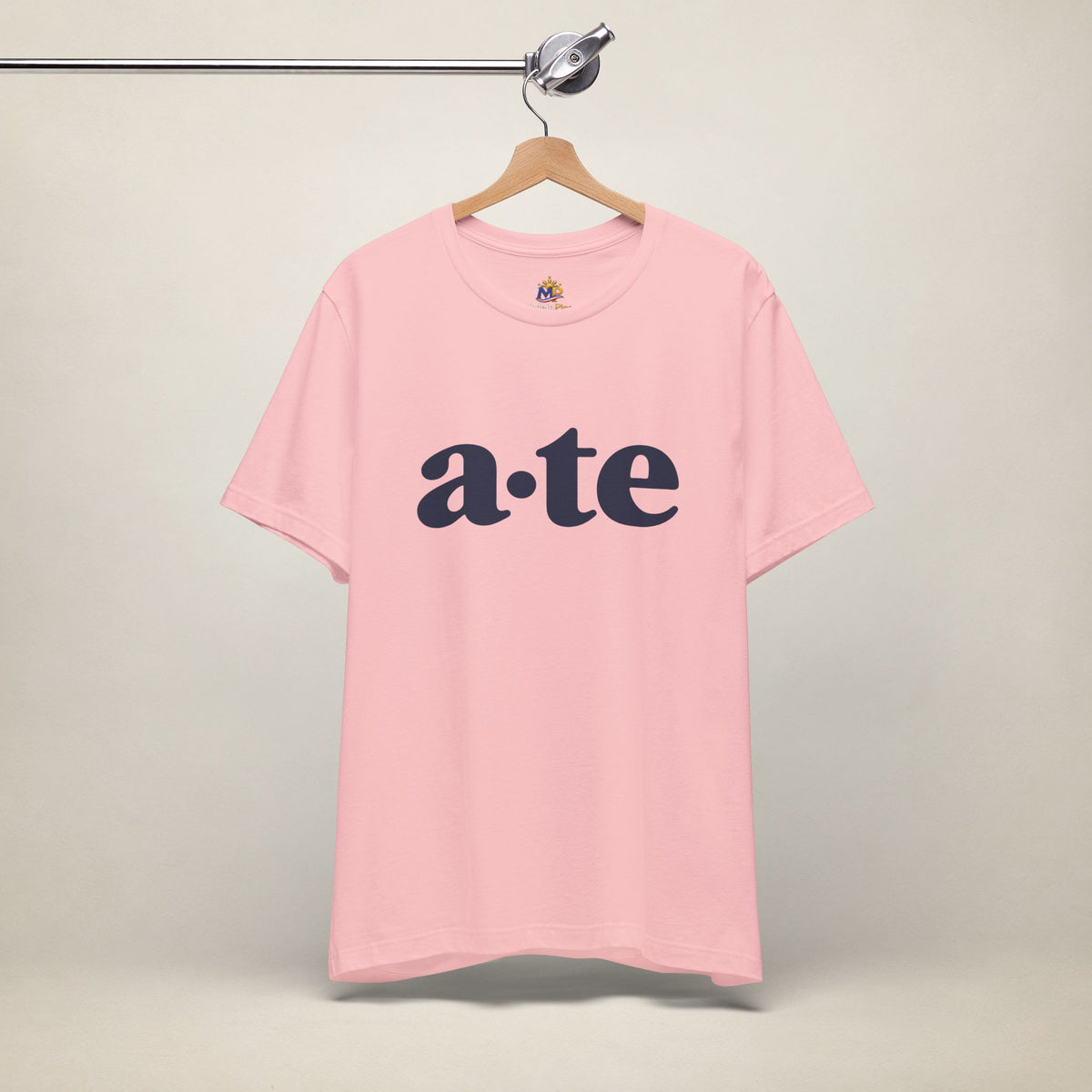 Pink MadeInPinas ATE Filipino T-shirt on a hanger, front view with minimalist a·te lettering.