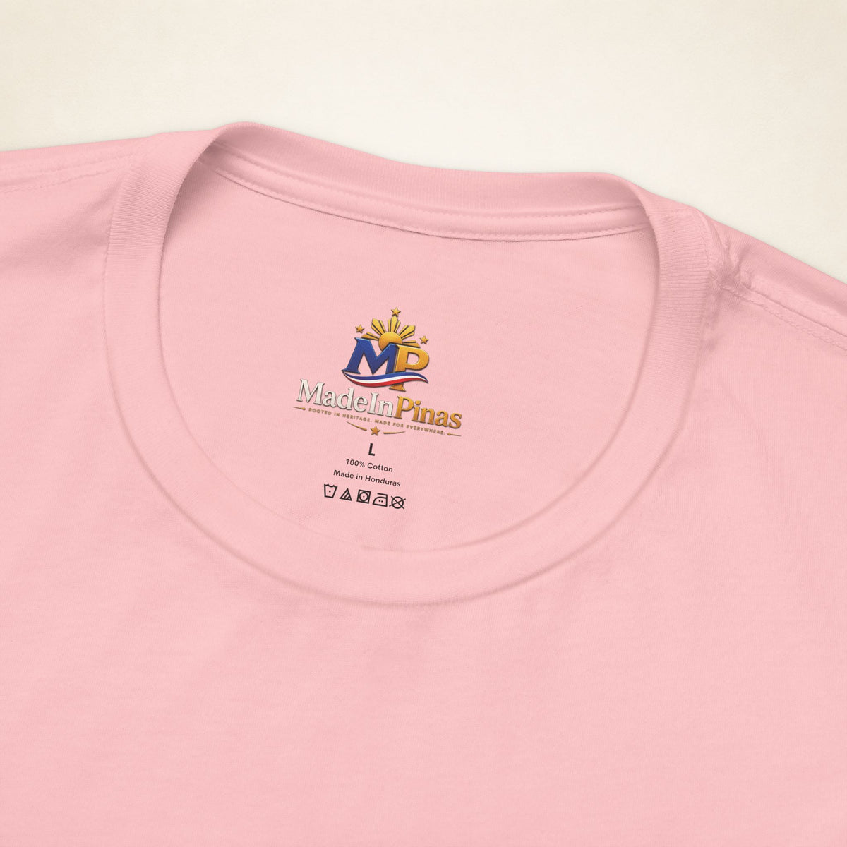 Close-up of the Pink ATE T-shirt collar showing the printed MadeInPinas inner-neck logo.