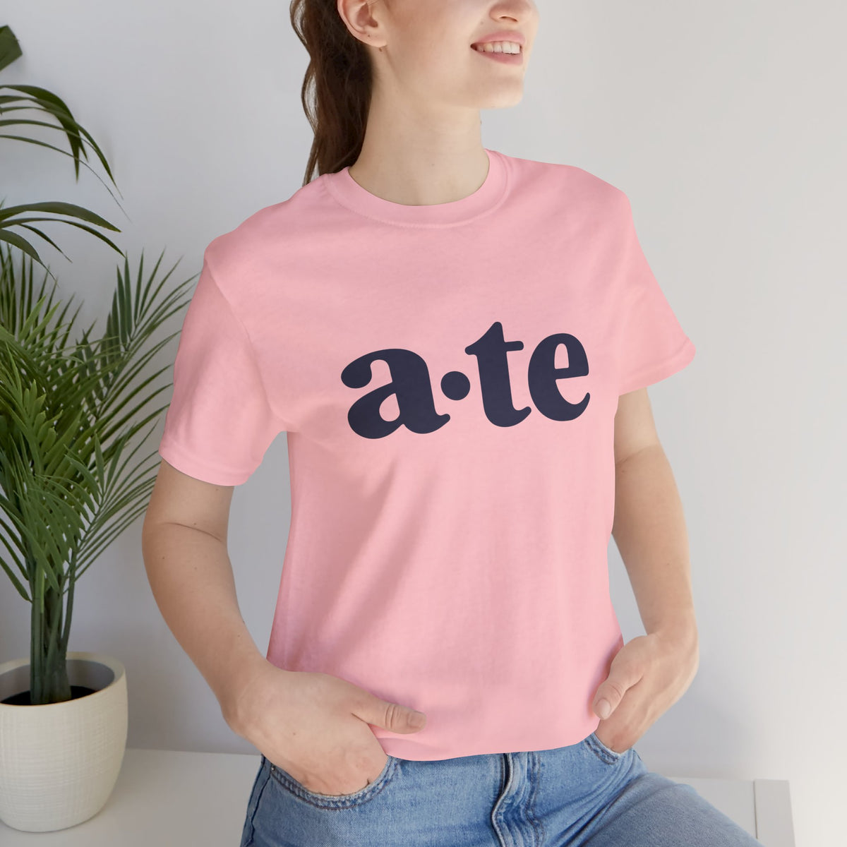 Lifestyle front view of a model wearing the Pink ATE Filipino T-shirt with minimalist a·te lettering.