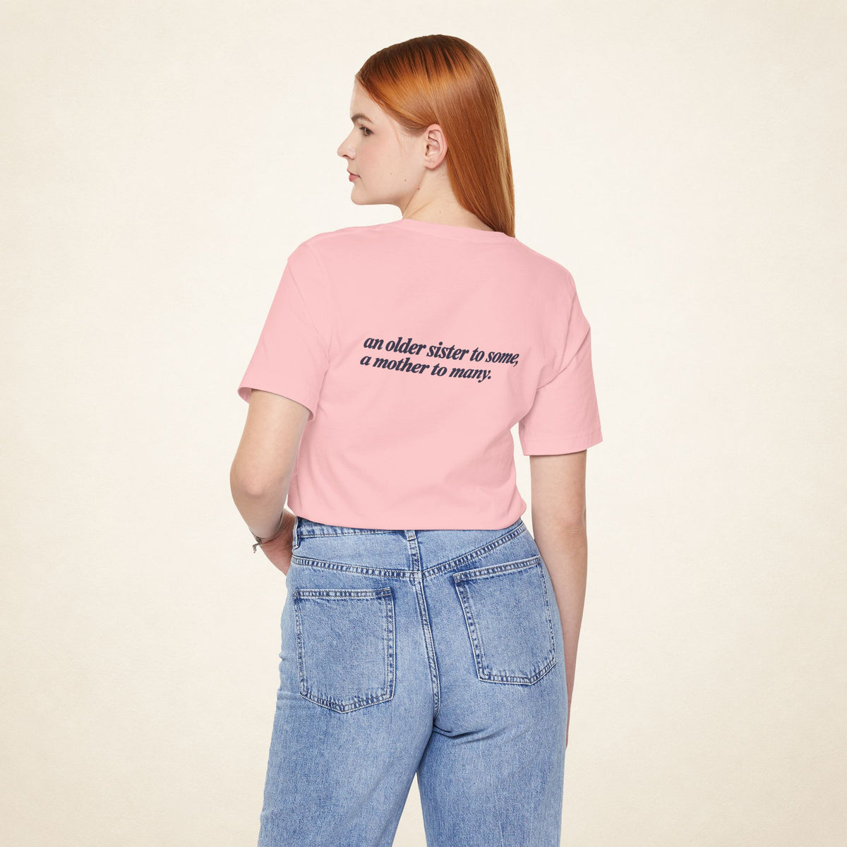 Model wearing the Pink ATE Filipino T-shirt from behind, with the message “an older sister to some, a mother to many.”