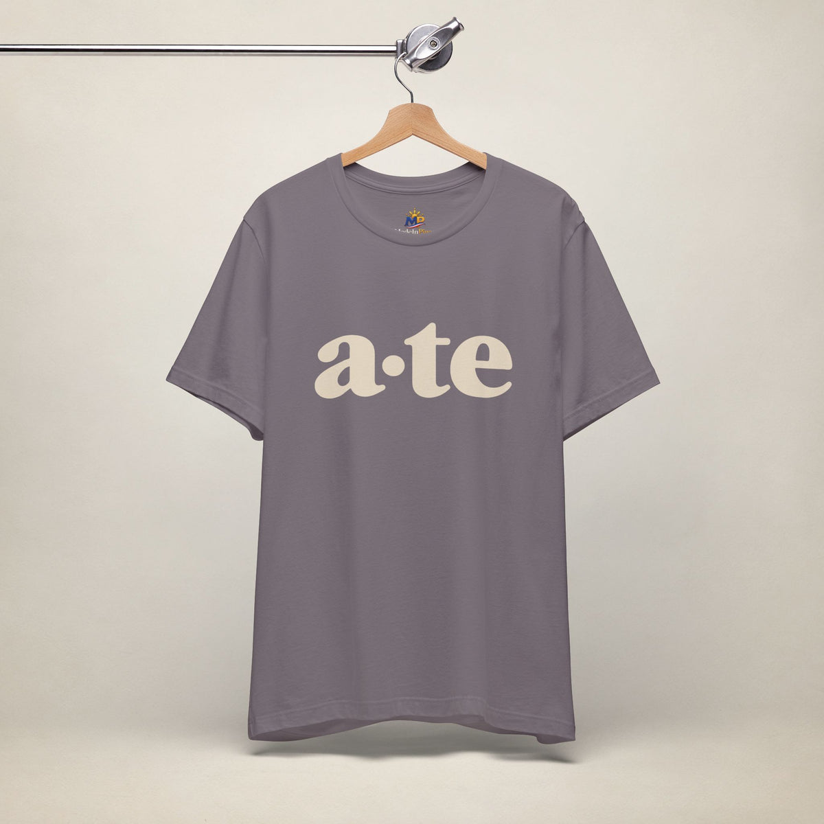 Storm MadeInPinas ATE Filipino T-shirt on a hanger, front view with minimalist a·te lettering.