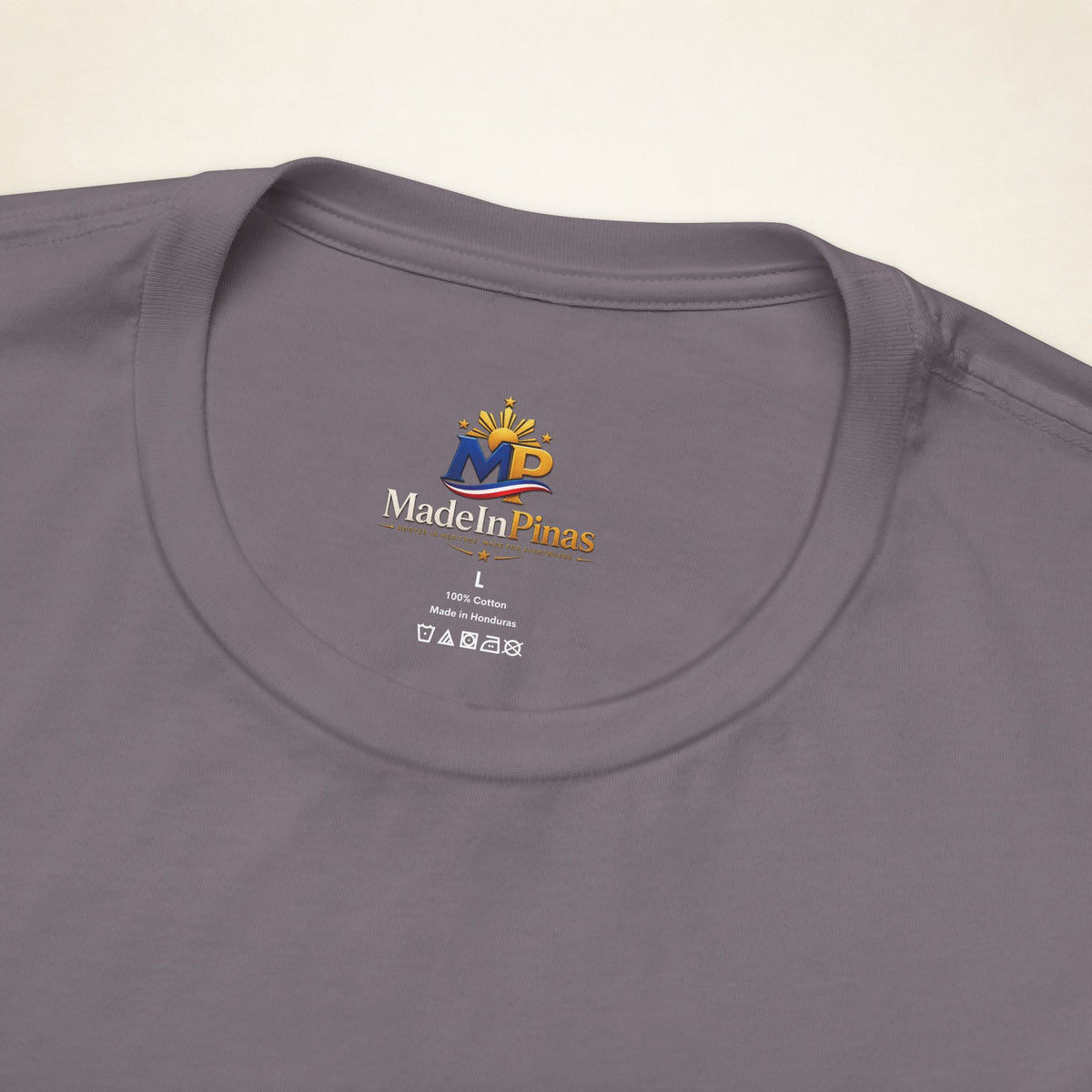 Close-up of the Storm ATE T-shirt collar showing the printed MadeInPinas inner-neck logo.