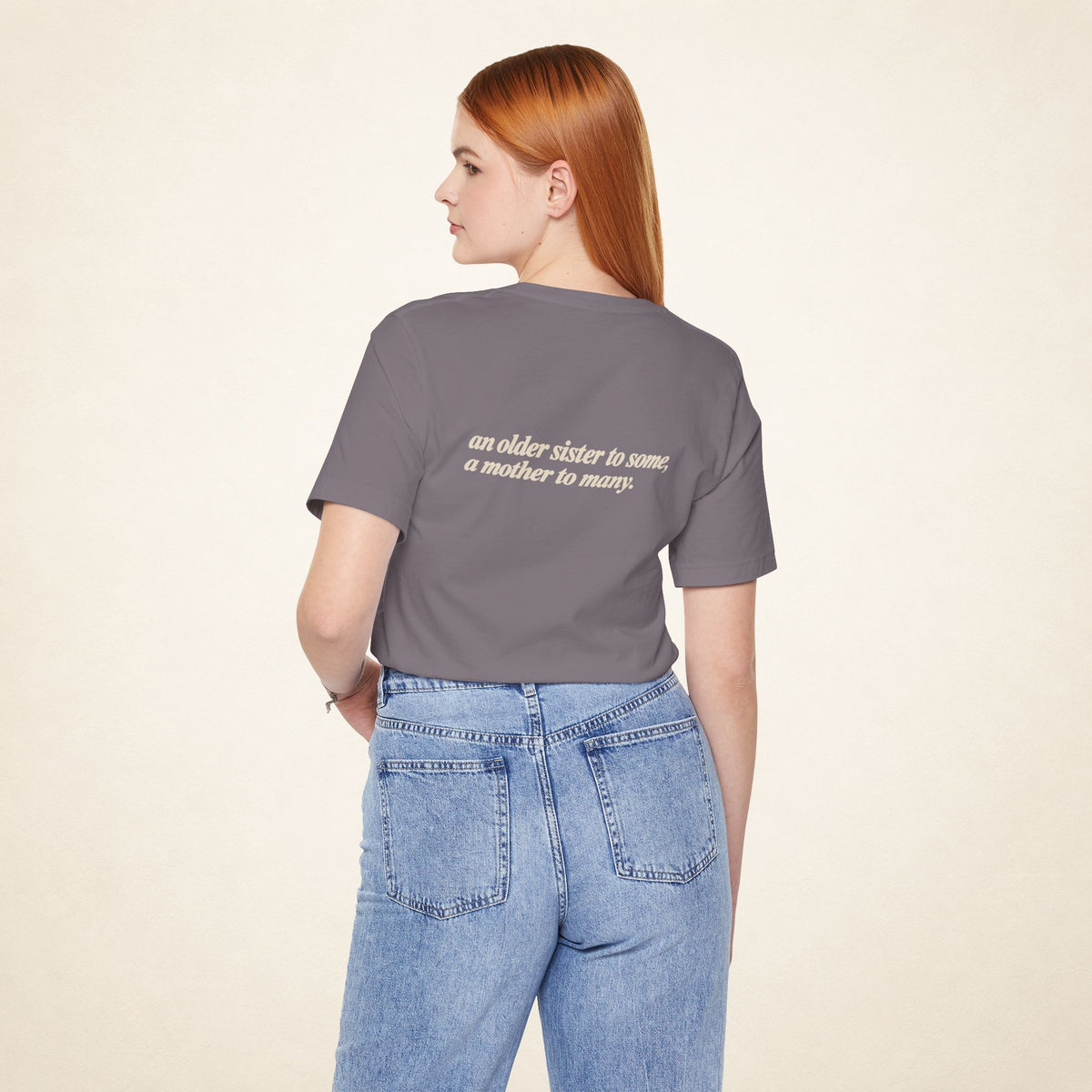 Model wearing the Storm ATE Filipino T-shirt from behind, with the message “an older sister to some, a mother to many.”