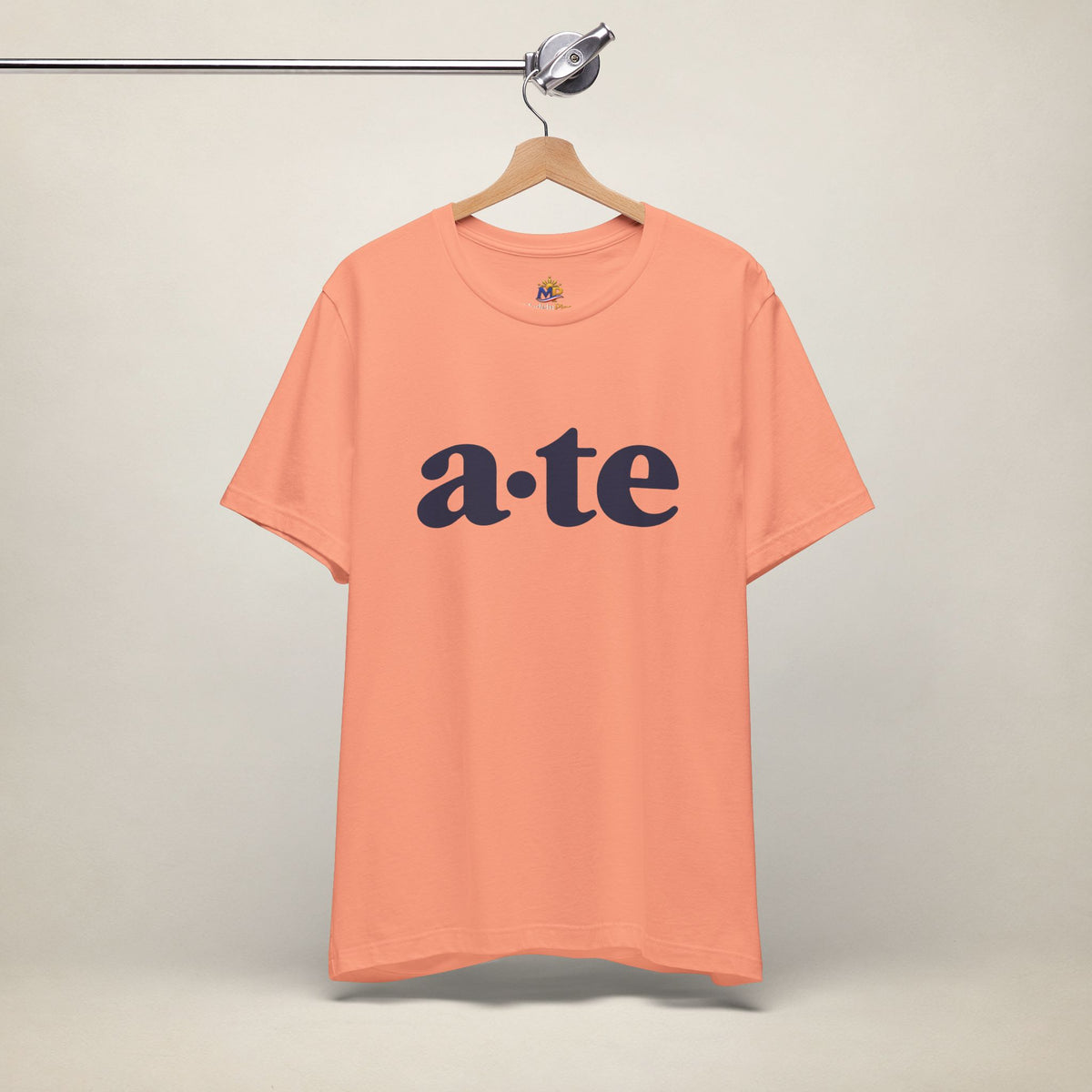 Sunset MadeInPinas ATE Filipino T-shirt on a hanger, front view with minimalist a·te lettering.