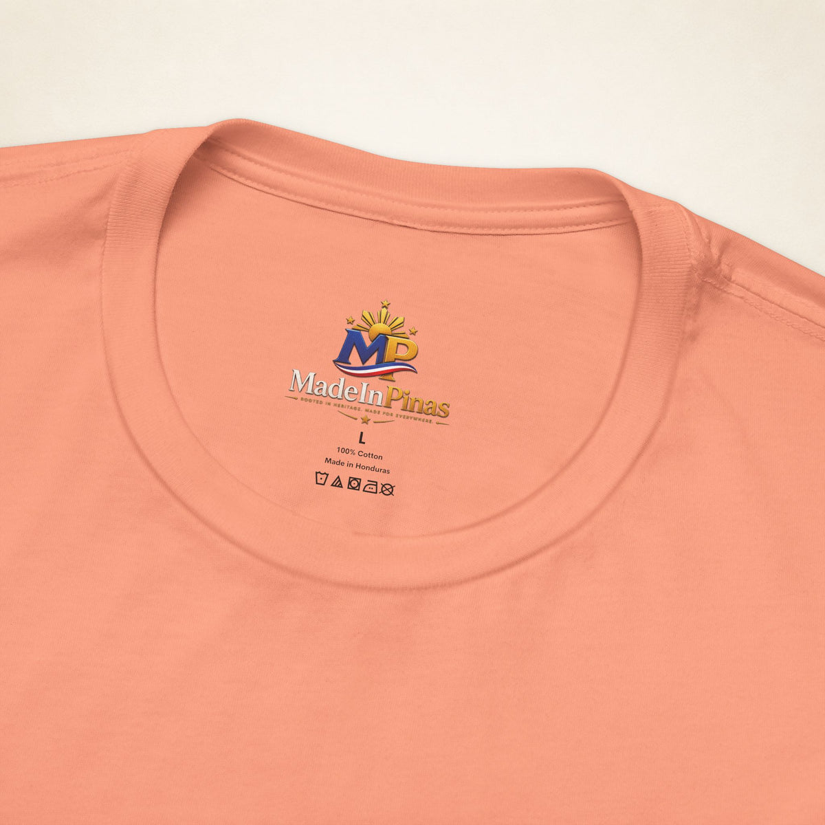Close-up of the Sunset ATE T-shirt collar showing the printed MadeInPinas inner-neck logo.