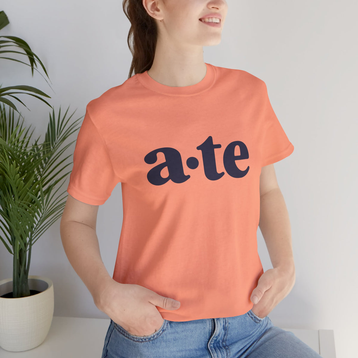 Lifestyle front view of a model wearing the Sunset ATE Filipino T-shirt with minimalist a·te lettering.