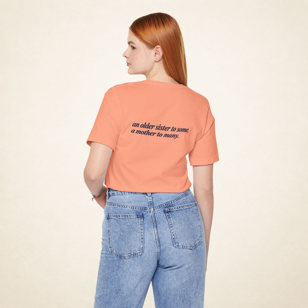 Model wearing the Sunset ATE Filipino T-shirt from behind, with the message “an older sister to some, a mother to many.”