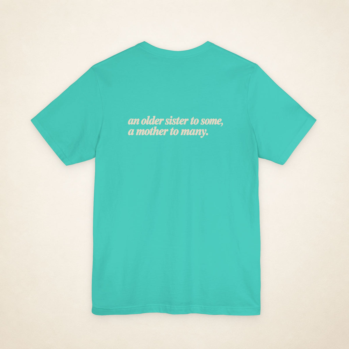 Teal ATE Filipino T-shirt, flat-lay back view with the message “an older sister to some, a mother to many.”