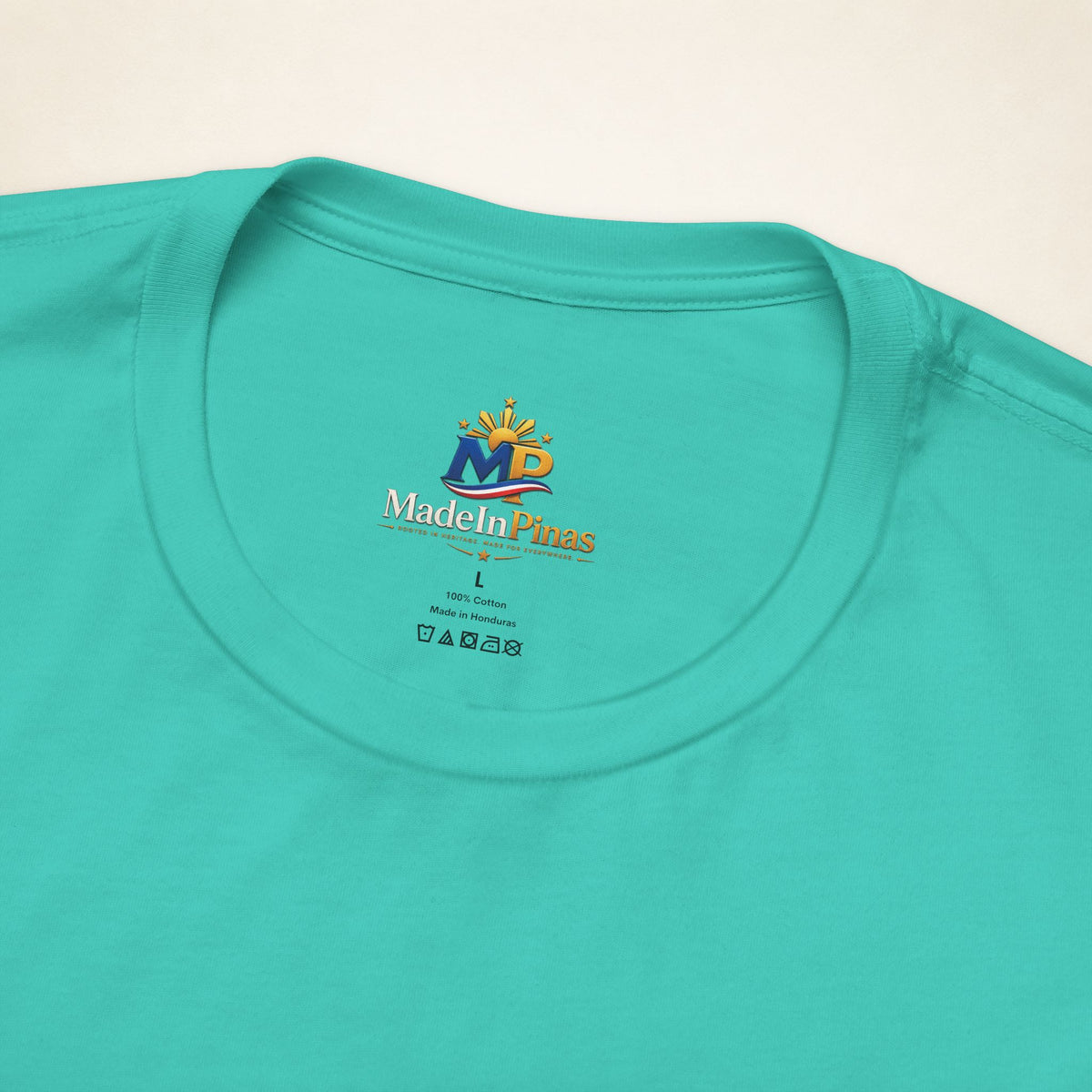 Close-up of the Teal ATE T-shirt collar showing the printed MadeInPinas inner-neck logo.