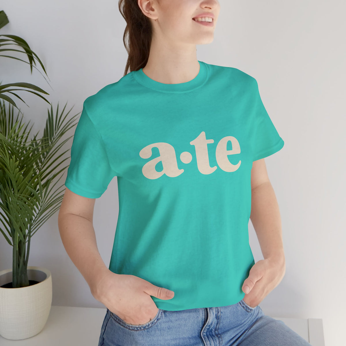 Lifestyle front view of a model wearing the Teal ATE Filipino T-shirt with minimalist a·te lettering.