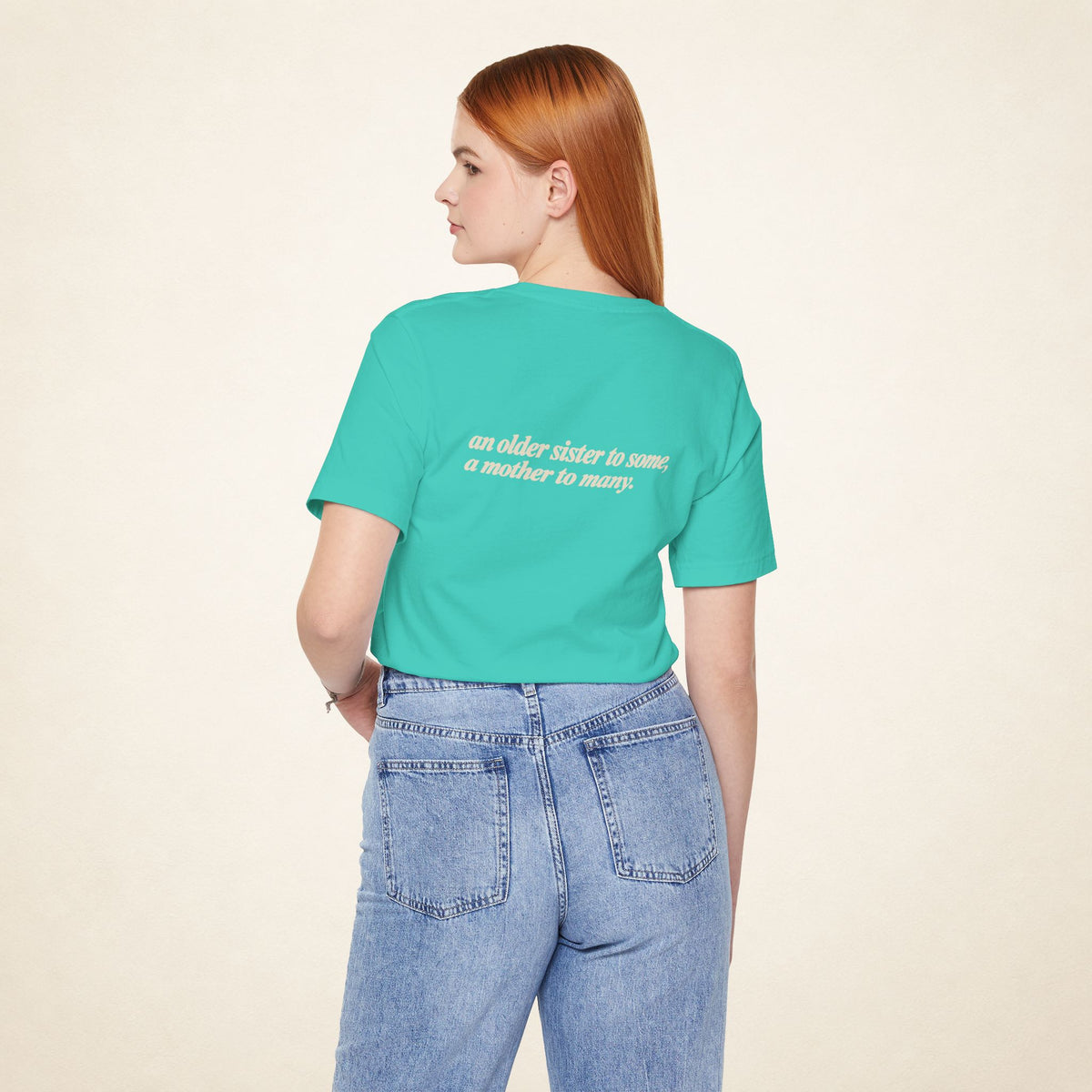 Model wearing the Teal ATE Filipino T-shirt from behind, with the message “an older sister to some, a mother to many.”