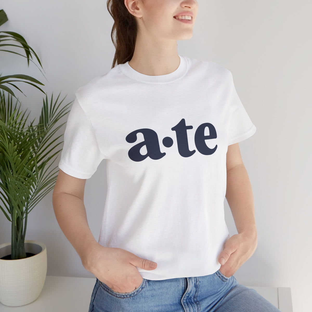 Lifestyle front view of a model wearing the White ATE Filipino T-shirt with minimalist a·te lettering.