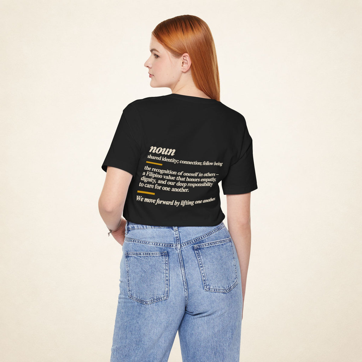 Model wearing the Black KAPWA T-shirt from behind, showing the shared humanity back design.