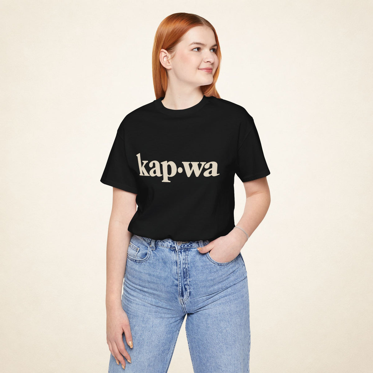 Model wearing the Black KAPWA Filipino graphic tee, front view with kap·wa typography.