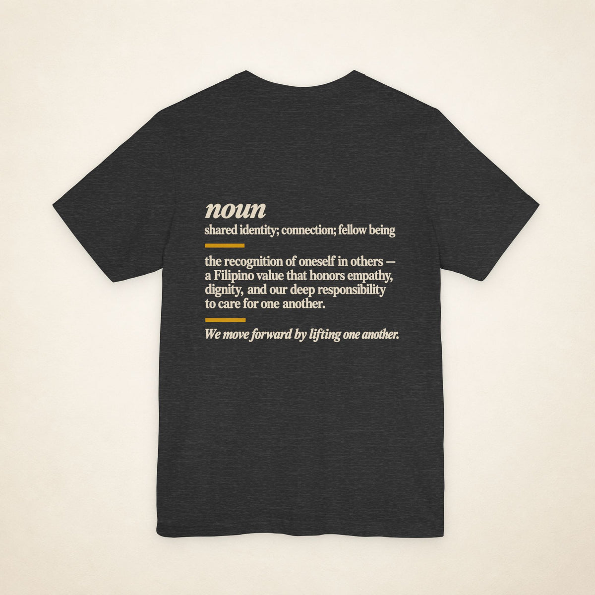 Back of the Dark Grey Heather KAPWA graphic T-shirt showing the dictionary-inspired shared identity message.