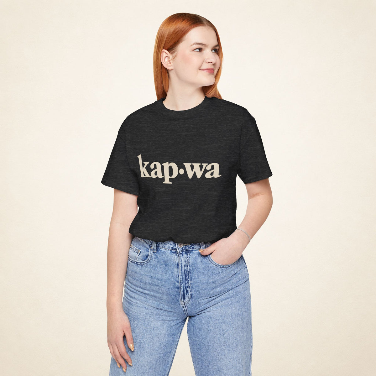 Model wearing the Dark Grey Heather KAPWA Filipino graphic tee, front view with kap·wa typography.