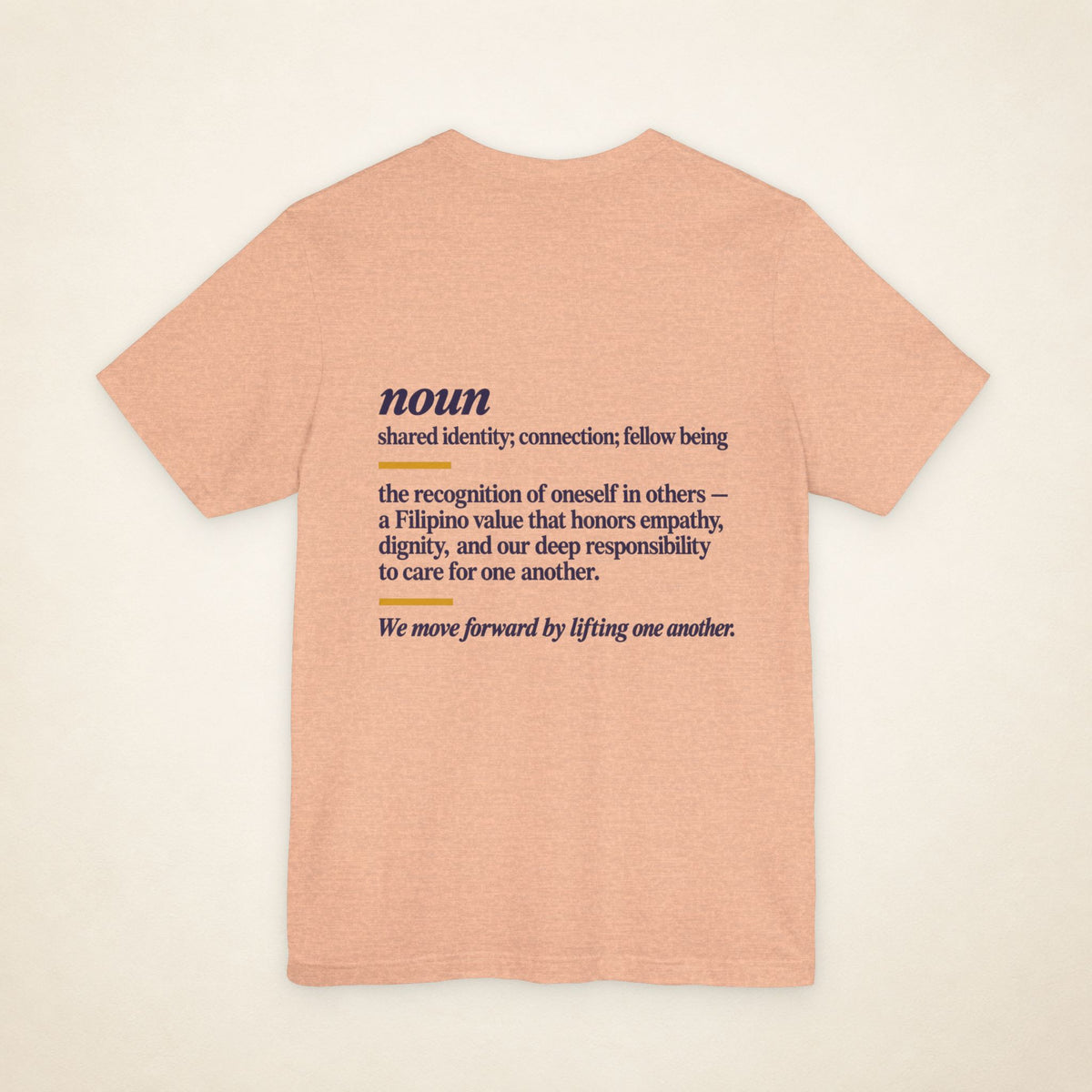 Back of the Heather Peach KAPWA graphic T-shirt showing the dictionary-inspired shared identity message.