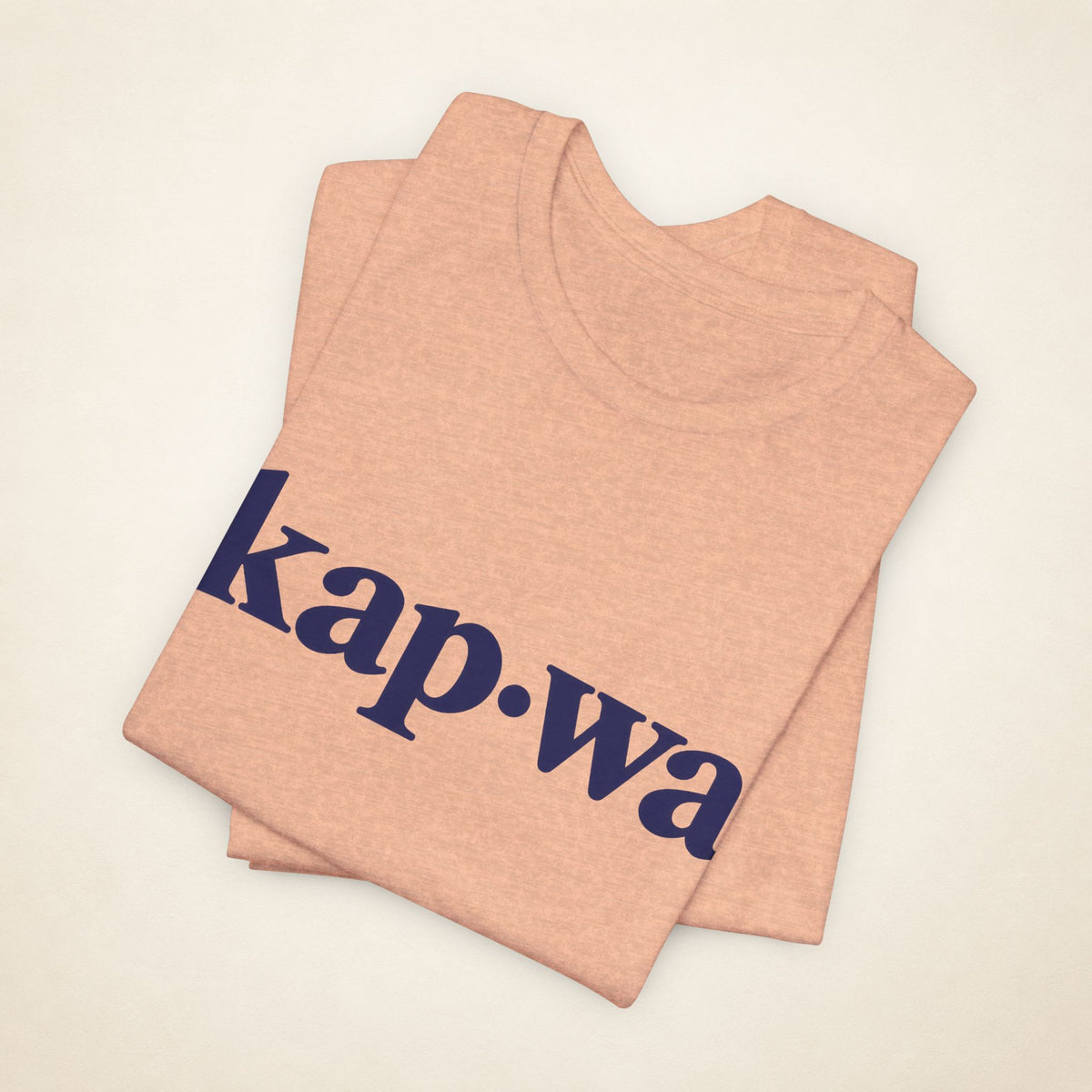 Folded Heather Peach MadeInPinas KAPWA T-shirt with the kap·wa front print visible.