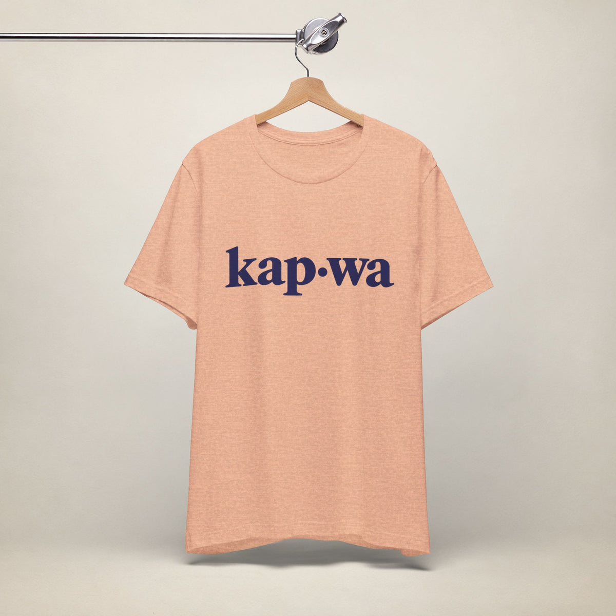 MadeInPinas KAPWA Filipino heritage T-shirt in Heather Peach, hanging front view with minimalist kap·wa lettering.