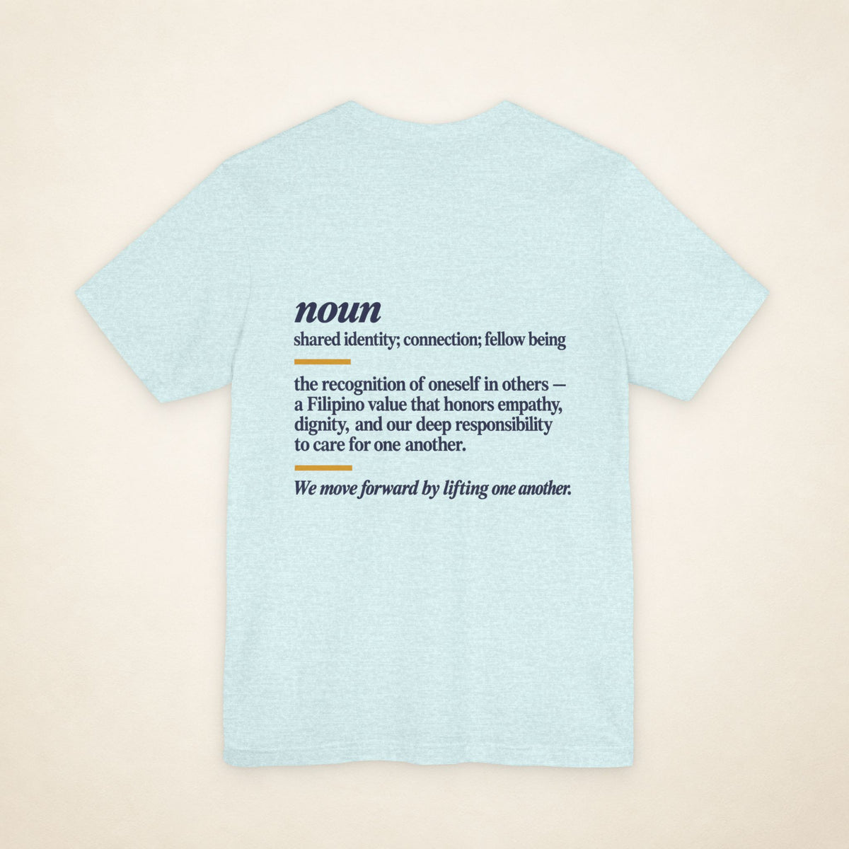 Back of the Heather Prism Ice Blue KAPWA graphic T-shirt showing the dictionary-inspired shared identity message.