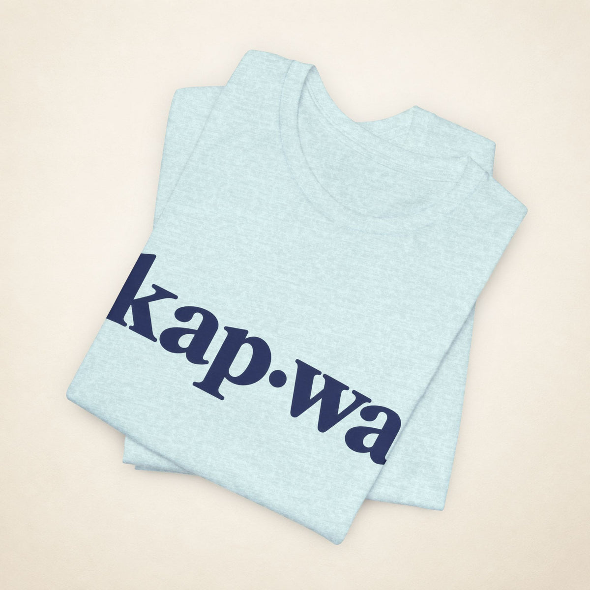 Folded Heather Prism Ice Blue MadeInPinas KAPWA T-shirt with the kap·wa front print visible.