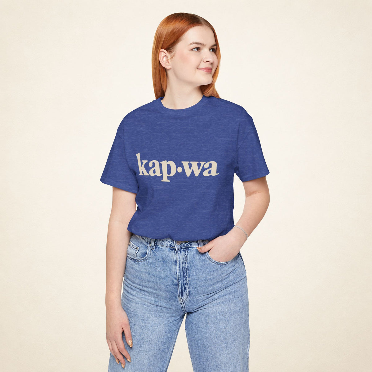 Model wearing the Heather True Royal KAPWA Filipino graphic tee, front view with kap·wa typography.