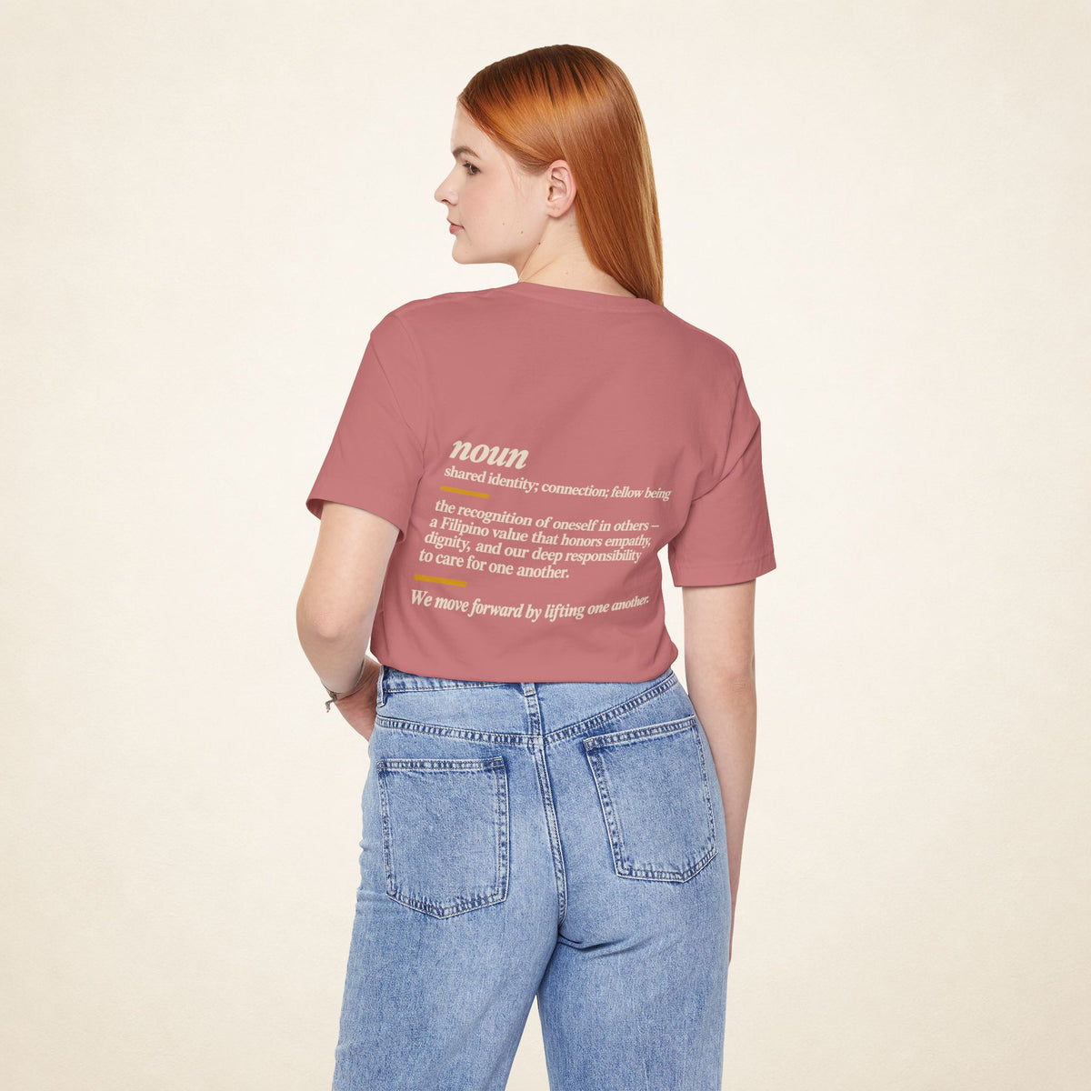 Model wearing the Mauve KAPWA T-shirt from behind, showing the shared humanity back design.