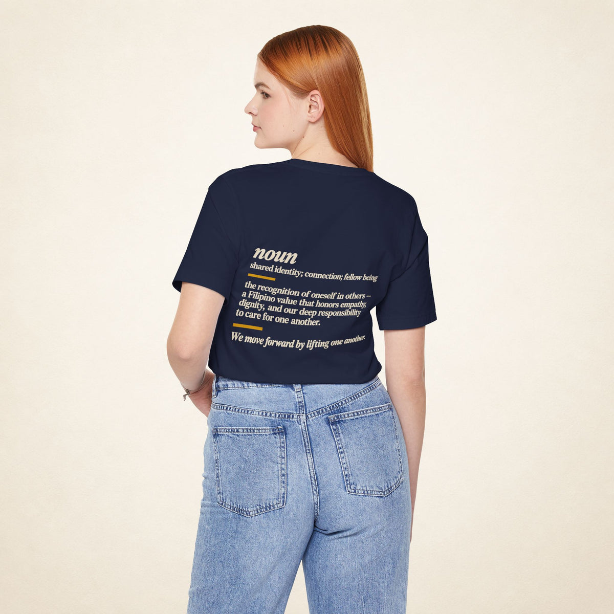 Model wearing the Navy KAPWA T-shirt from behind, showing the shared humanity back design.