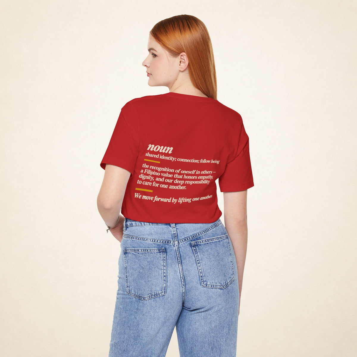 Model wearing the Red KAPWA T-shirt from behind, showing the shared humanity back design.