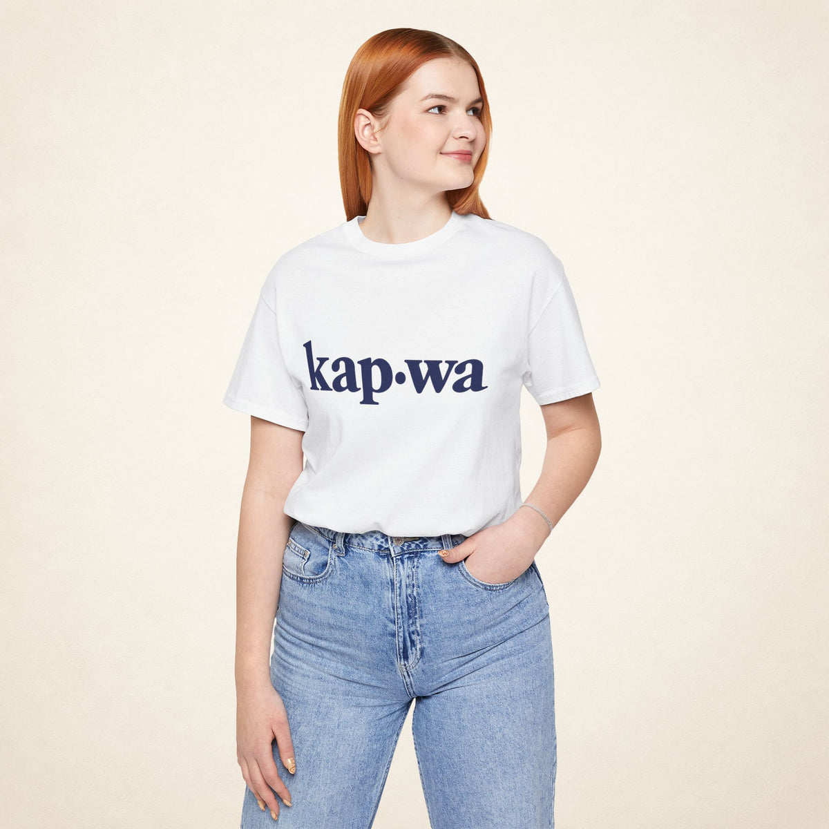 Model wearing the White KAPWA Filipino graphic tee, front view with kap·wa typography.